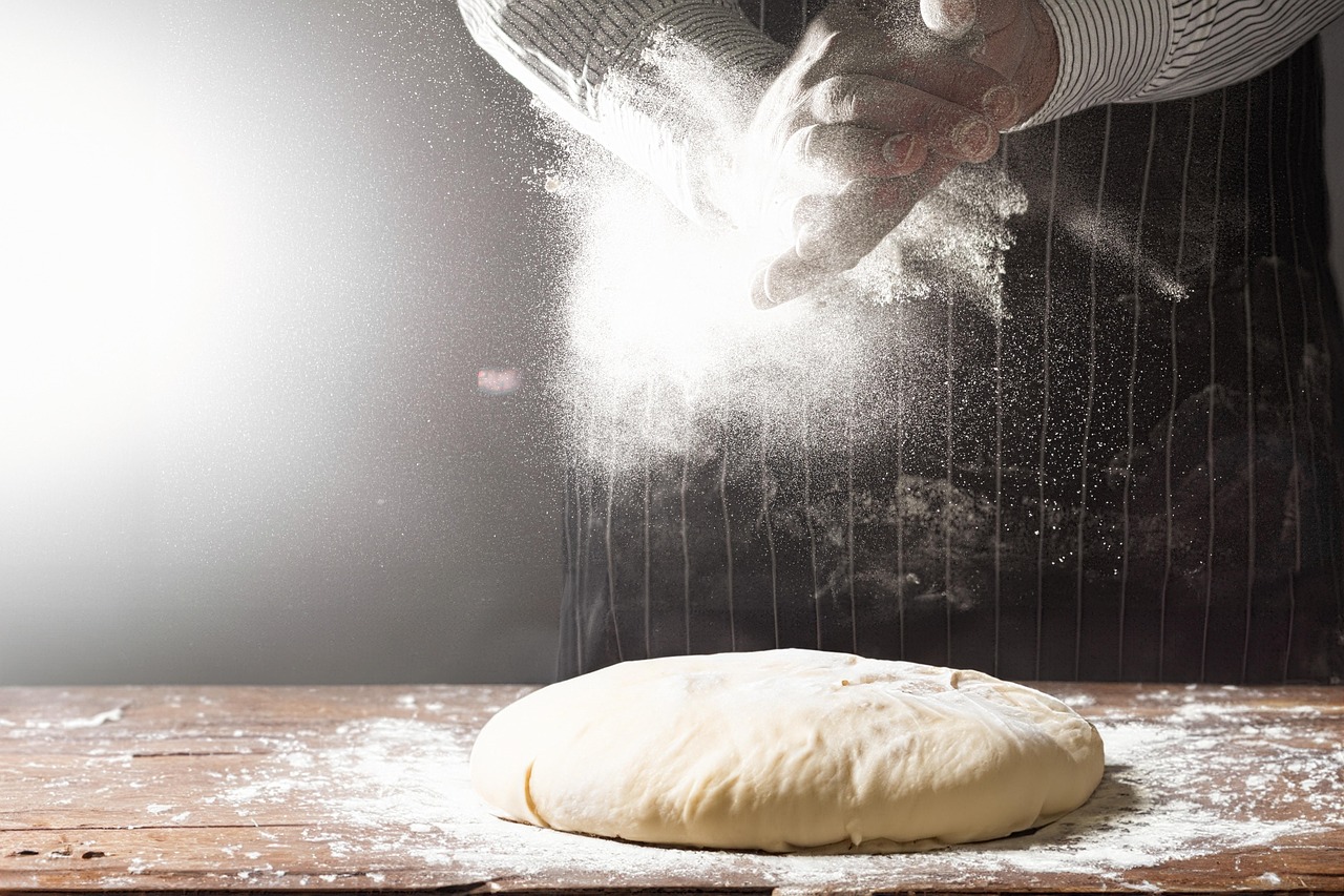 Baker shaping dough by hand in the kitchen